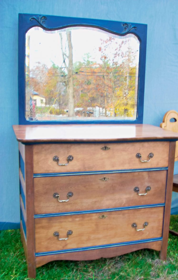Two-toned wood dresser and painted square mirror